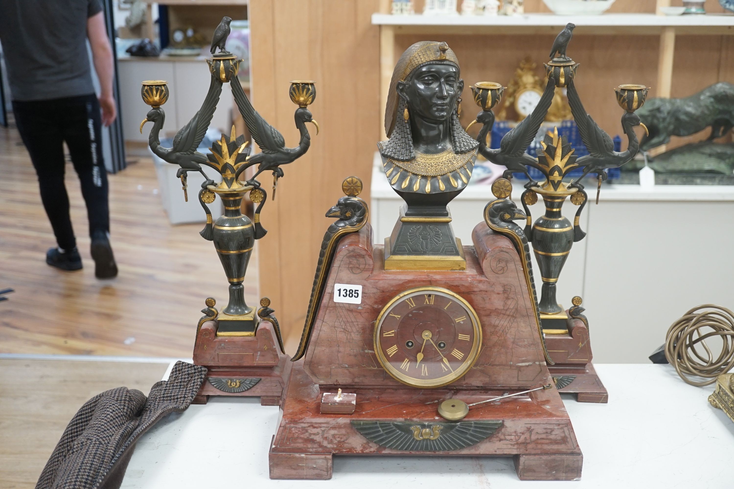 A late 19th century French Egyptian Revival gilt bronze and rouge marble clock garniture, 51cm